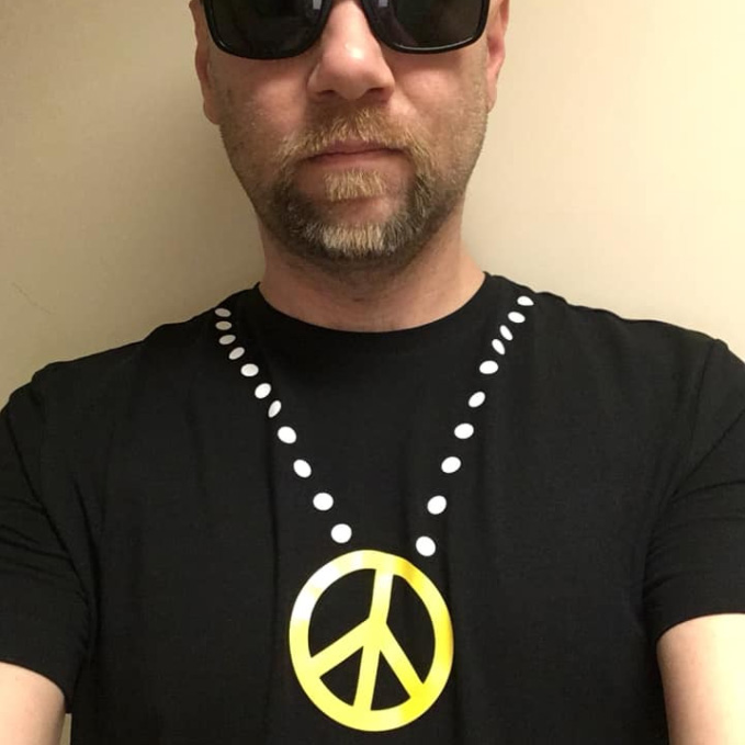 The designer wearing the peace t-shirt